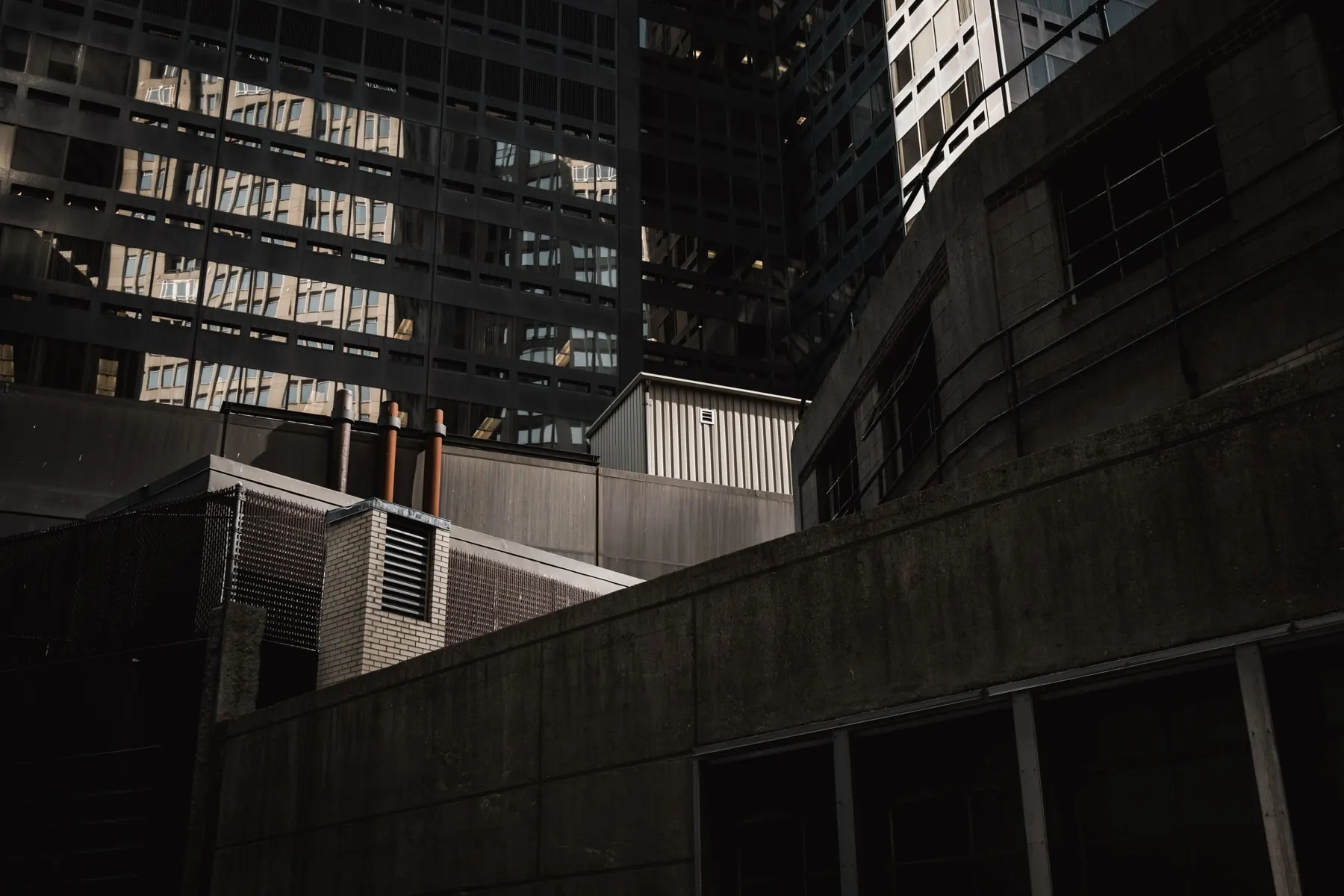Dark office facade above a concrete service yard