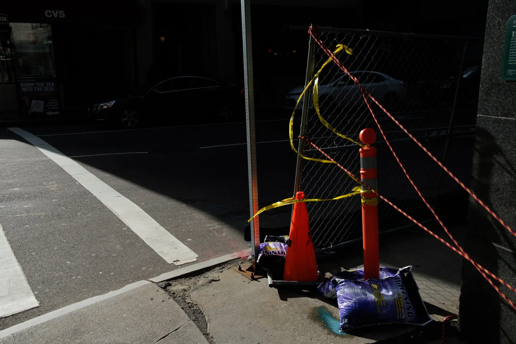 Cone and posts tied with tape at a dark garage entrance
